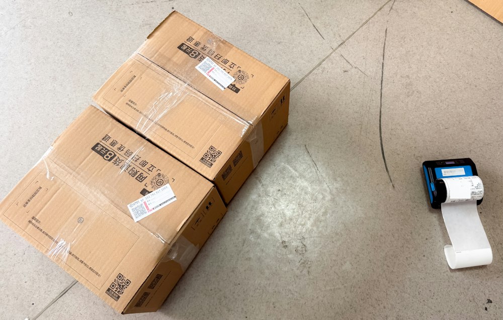 Packed parcels next to a shipping label printer
